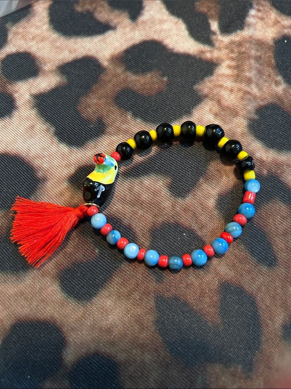 Hand Crafted Multicolor Beaded Parrot Bracelet with Red Tassel